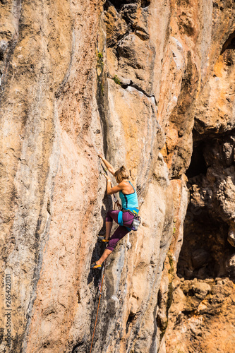 A girl climbs a rock. © zhukovvvlad