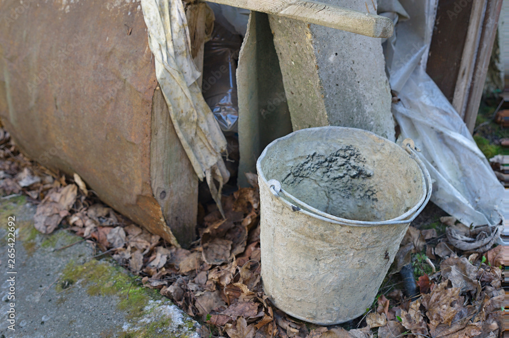 Abandoned empty bucket with dried cement Abandoned empty bucket with dried cement