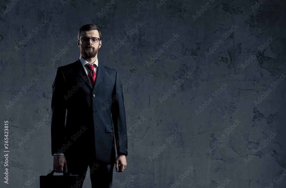 Businessman in formalwear over dark background. Business, finance, career and office concept. Businessman in formalwear over dark background. Business, finance, career and office concept.