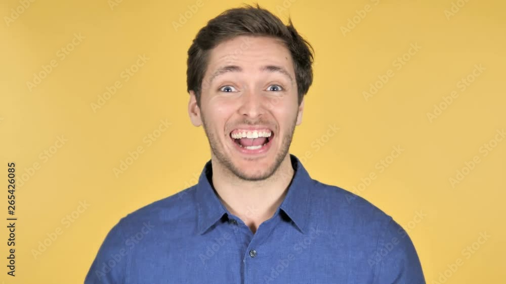 Casual Young Man Upset by Failure on Yellow Background Casual Young Man Upset by Failure on Yellow Background