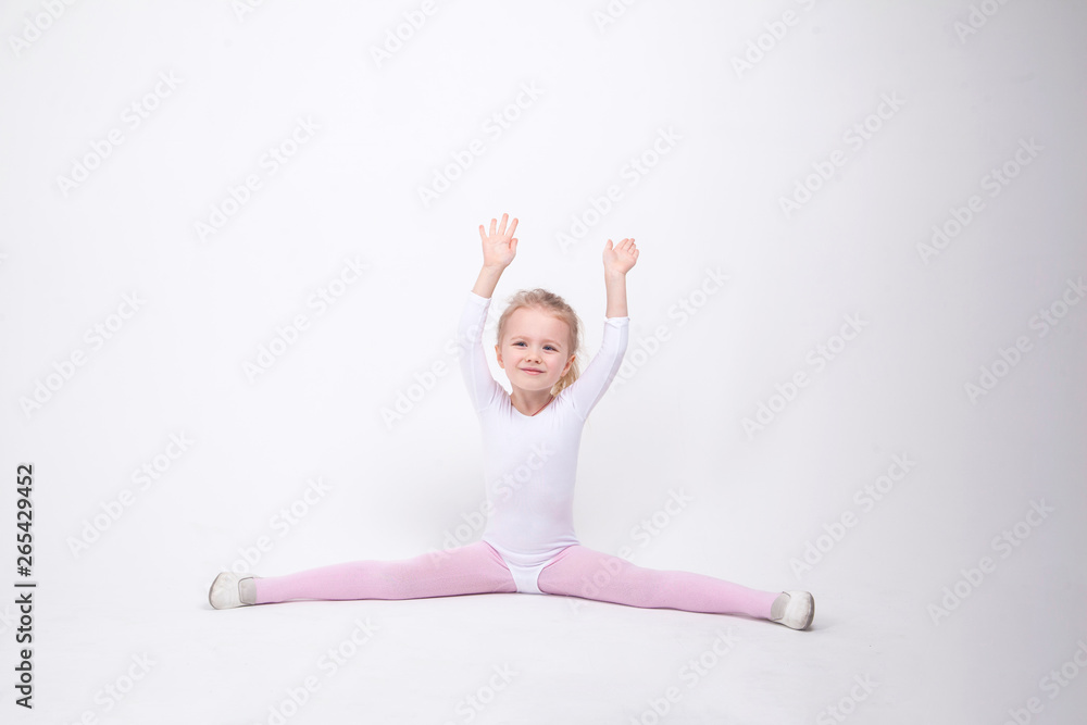 Smiling Little girl gymnast on a white background