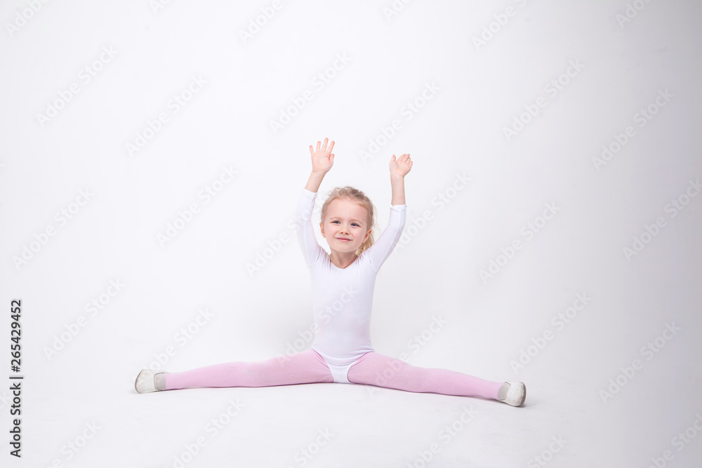 Smiling Little girl gymnast on a white background Smiling Little girl gymnast on a white background