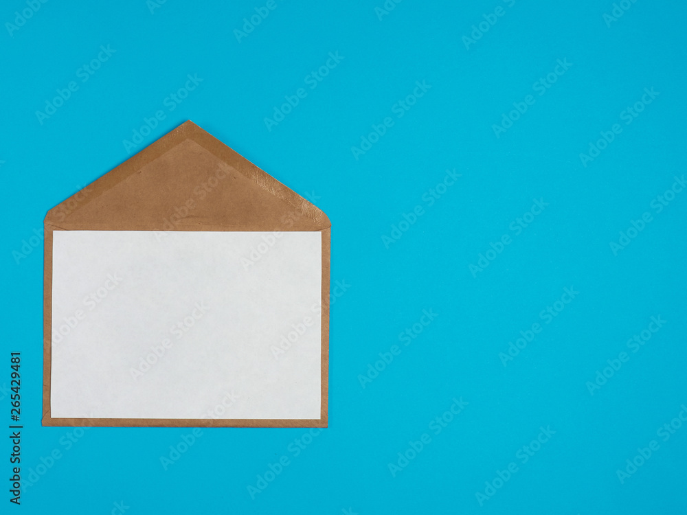 Craft envelope with a white sheet of paper on a blue background Craft envelope with a white sheet of paper on a blue background