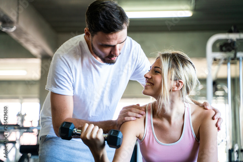 Healthy lifestyle couple working out in fitness gym