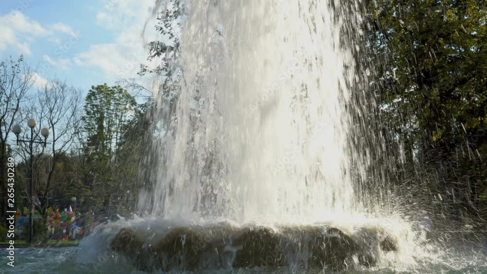 The jets of a powerful fountain in the city Park are illuminated from behind by bright sunlight at sunset. Close up. 4K The jets of a powerful fountain in the city Park are illuminated from behind by bright sunlight at sunset. Close up. 4K