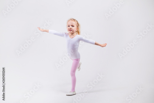 Happy little girl dancing isolated on white background
