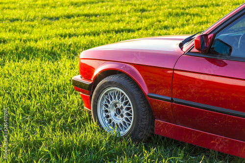 Front left side of an old German car that stands on green grass