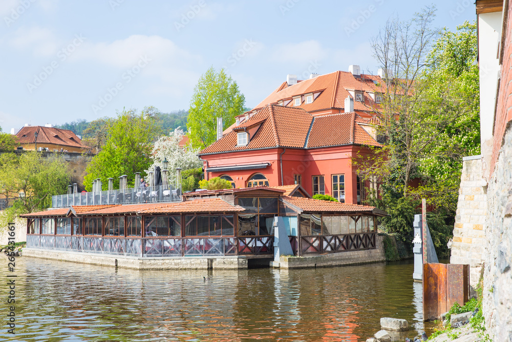 Old  buildings and street view. Vltava river with glare. Travel photo 2019.