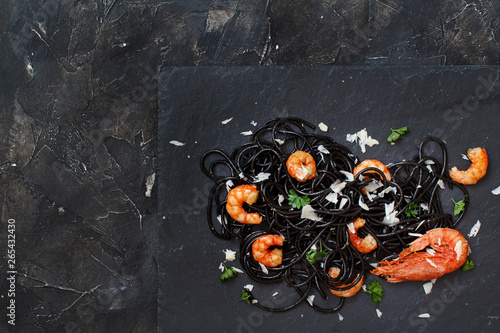 Squid ink pasta with prawns and tomatoes