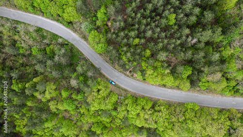 Fototapeta Naklejka Na Ścianę i Meble -  Aerial view of road through forest