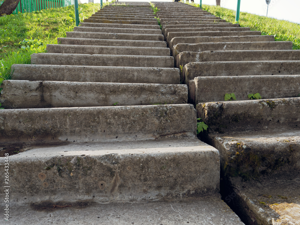 concrete staircase on a steep slope of green grass concrete staircase on a steep slope of green grass