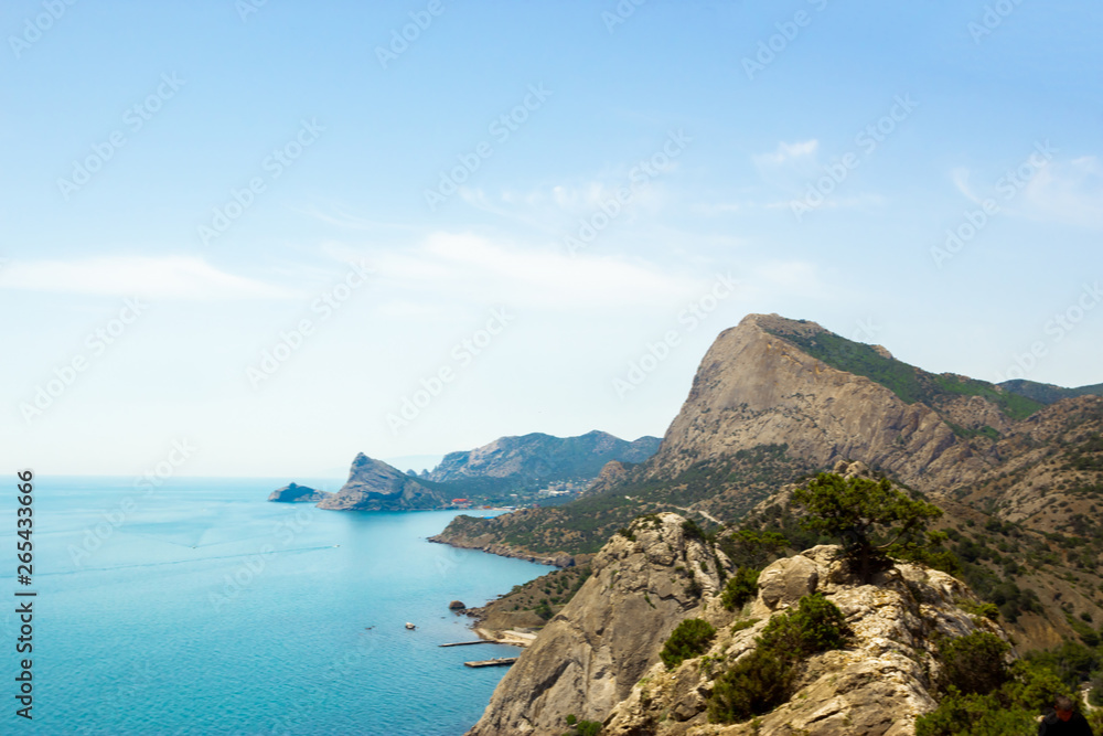 The view from the heights of the mountains, the sea and the blue sky with white clouds