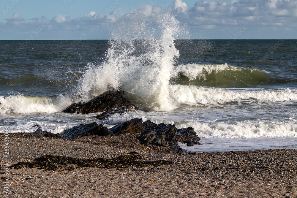 Big wave hits rock during spring tide. Big wave hits rock during spring tide.