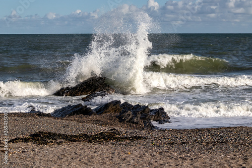 Big wave hits rock during spring tide.