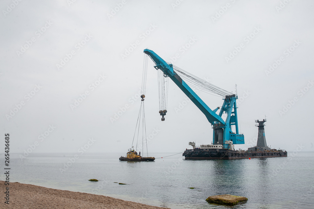a large floating crane saves a barge aground in Odessa