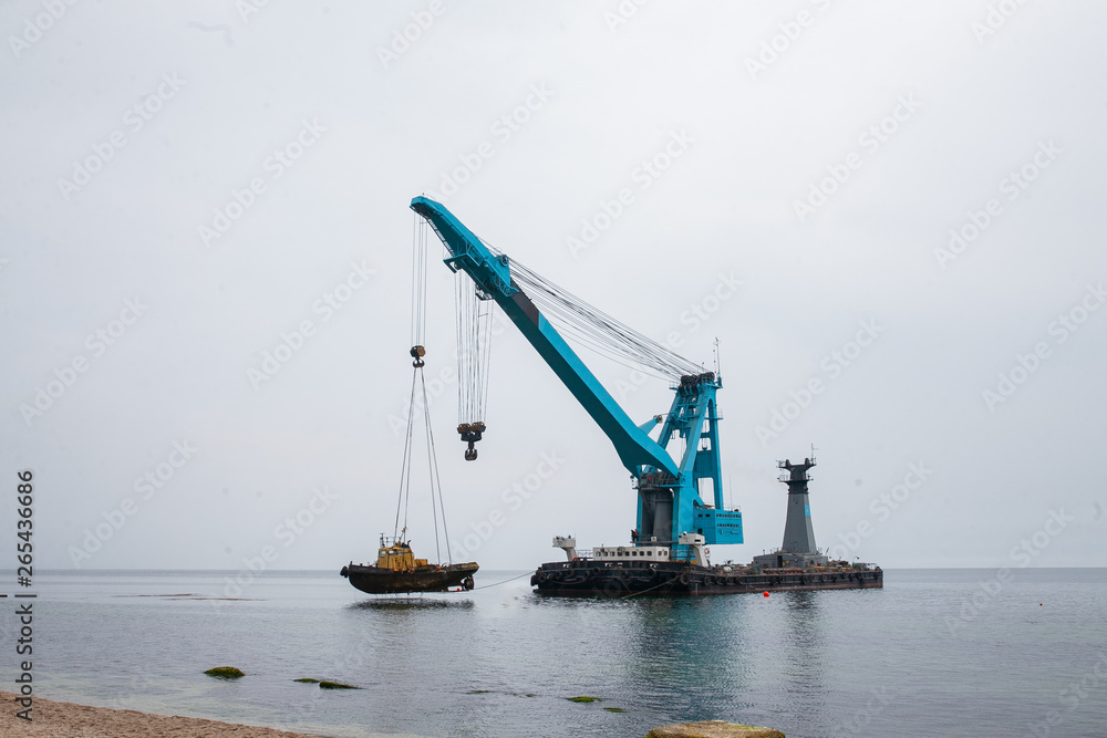 a large floating crane saves a barge aground in Odessa