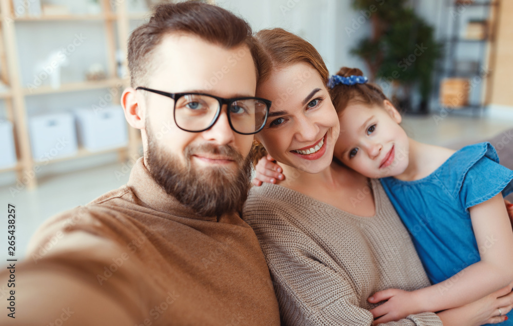 cheerful happy family mother father and child take selfies, take pictures. cheerful happy family mother father and child take selfies, take pictures.
