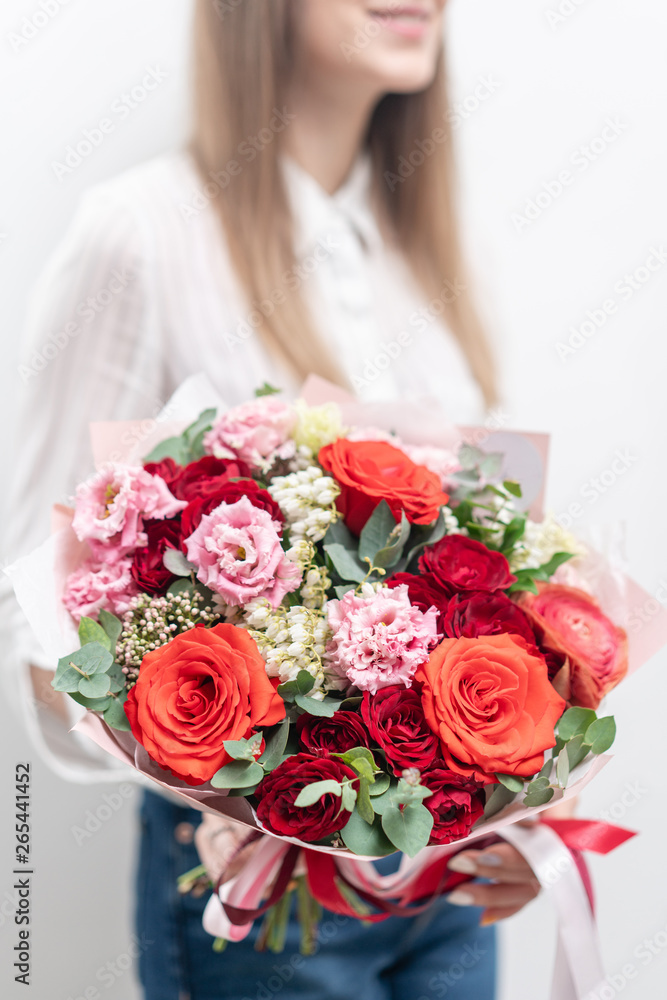 Beautiful bouquet of mixed flowers in womans hands. the work of the florist at a flower shop. Delicate Pastel color. Fresh cut flower. Red and pink color Beautiful bouquet of mixed flowers in womans hands. the work of the florist at a flower shop. Delicate Pastel color. Fresh cut flower. Red and pink color