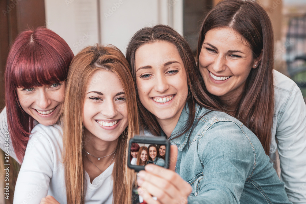 four young vloggers take a selfie with a camera four young vloggers take a selfie with a camera