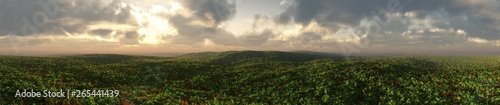 Panorama of green hills under a stormy sky  a beautiful view of the terrible plain 