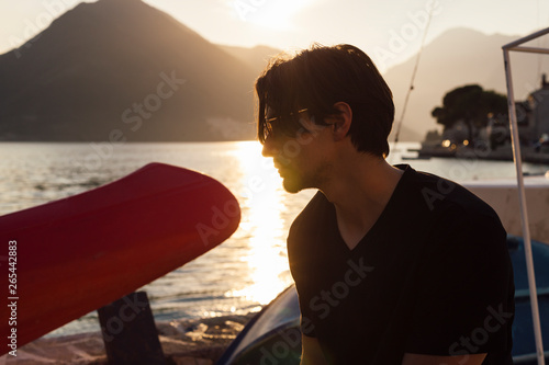 Man portrait by the sea at sunset.