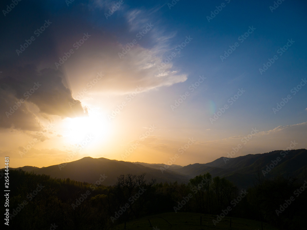 Beautiful landscape in the mountains at sunset. View of colorful sky with amazing clouds.