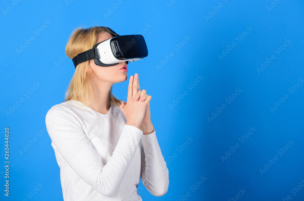 Woman excited using 3d goggles. Young woman using a virtual reality headset. Amazed young woman touching the air during the VR experience. VR image. Woman excited using 3d goggles. Young woman using a virtual reality headset. Amazed young woman touching the air during the VR experience. VR image.
