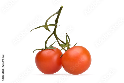Two small red cherry tomatoes on a green stalk on a neutral white background 