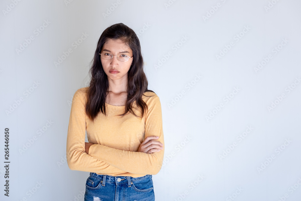 Portrait of offended woman with arms crossed looking at camera isolated on white background Portrait of offended woman with arms crossed looking at camera isolated on white background