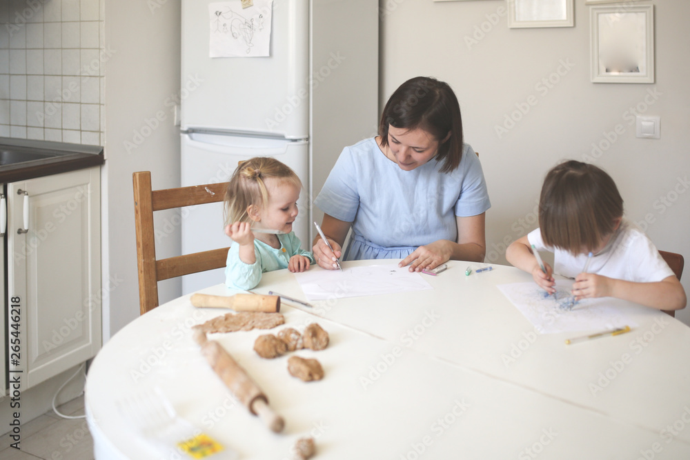 Mom paint with children at table in real kitchen Mom paint with children at table in real kitchen