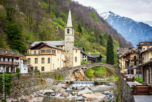 Fontainemore alpine village on the Lys river in a forest in the valley of Gressoney near Monte Rosa during spring