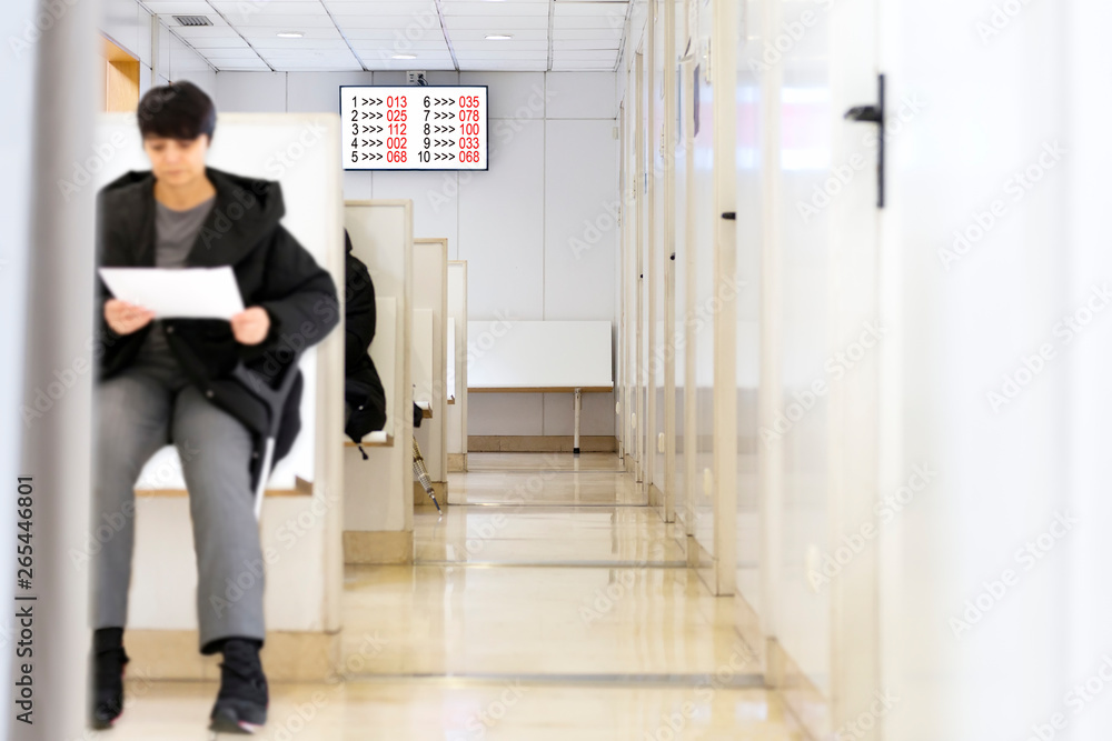 Fototapeta premium hospital waiting room with woman with medical appointment