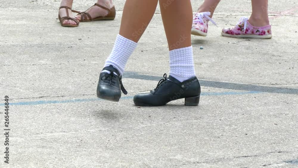 The girl shows the location of the legs during the movement of the Irish dance The girl shows the location of the legs during the movement of the Irish dance