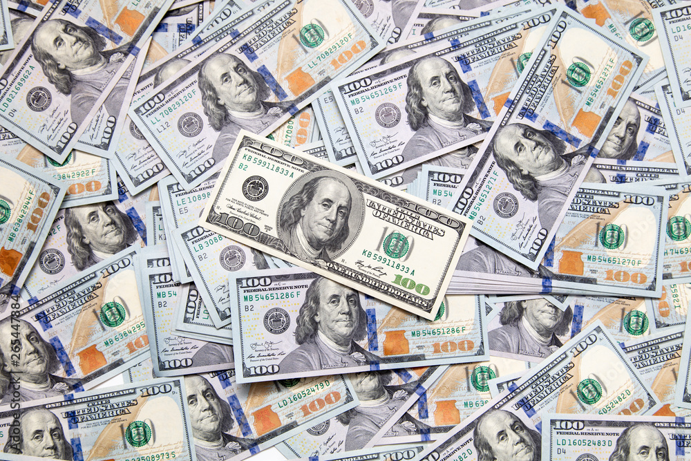 One hundred dollar bills on the table as background One hundred dollar bills on the table as background
