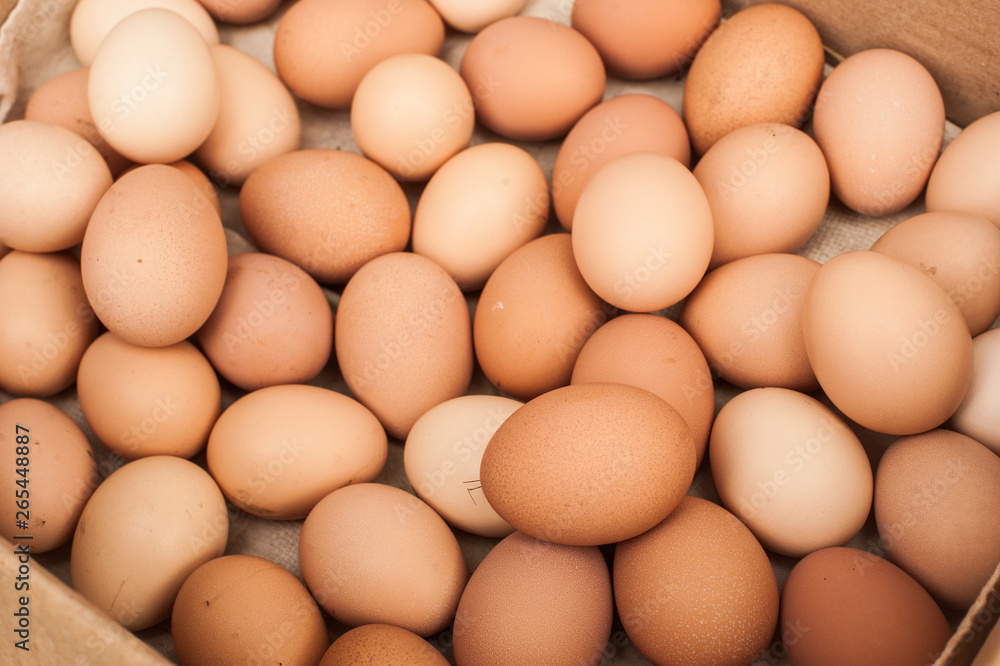 Many brown eggs in box. Chicken farm. Place for text. Preparation for Easter. Many brown eggs in box. Chicken farm. Place for text. Preparation for Easter.