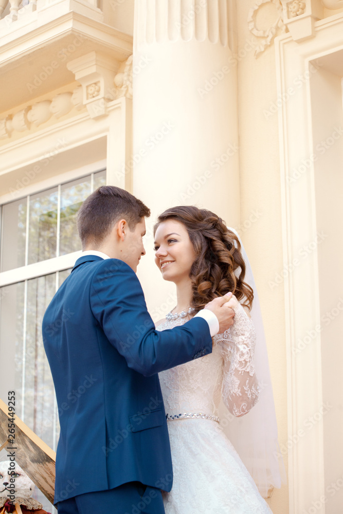 the bride and groom hold hands, look at each other. Wedding the bride and groom hold hands, look at each other. Wedding