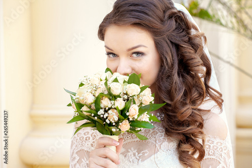 Wedding. The bride holds a bouquet, close-up. Looking at camera