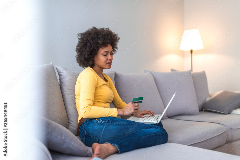 Internet payment. Happy cheerful woman looking at the Internet screen while making an Internet payment Internet payment. Happy cheerful woman looking at the Internet screen while making an Internet payment