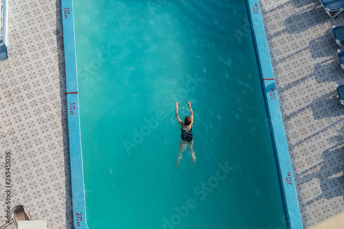 Swimmer in a hotel pool from above