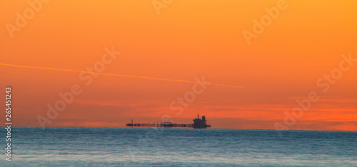 Freighter sailing at dawn