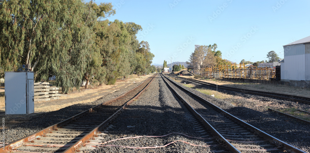 double level Railway crossing over a tar road in an industrial area in a small town, rural New South Wales, Australia