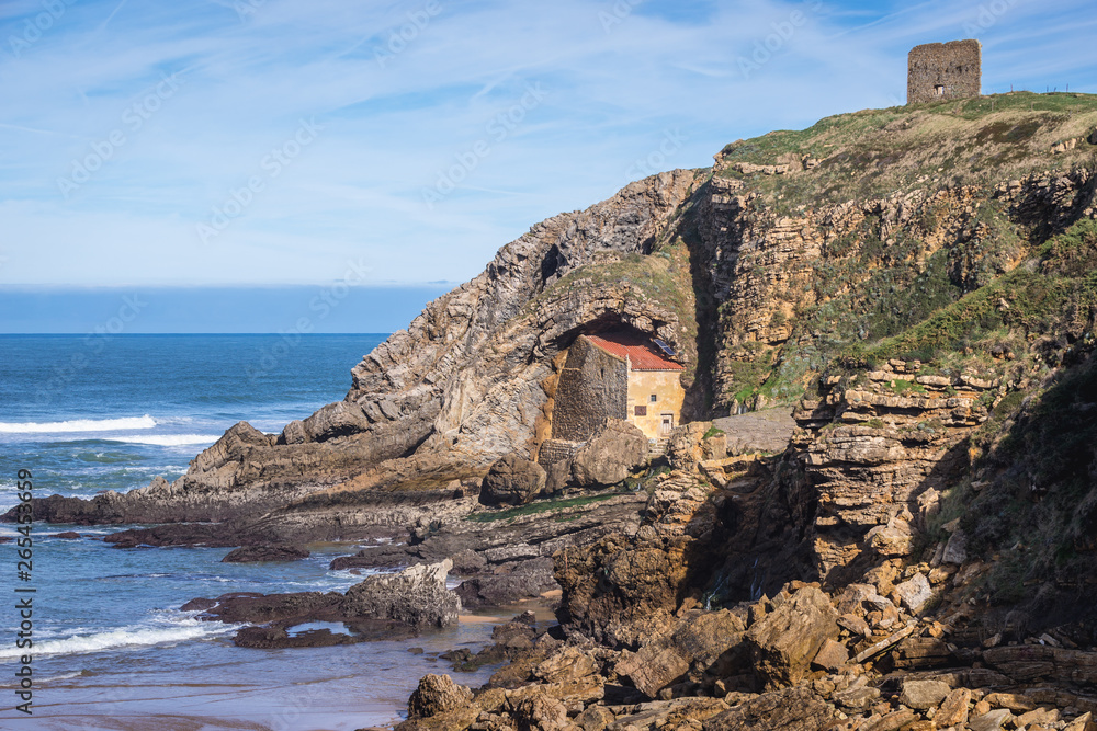 Santa Justa hermitage on the Atlantic shore in Ubiarco village in northern Spain, view with San Telmo medieval watchtower