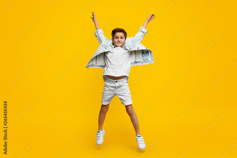 Boy raising hands and jumping