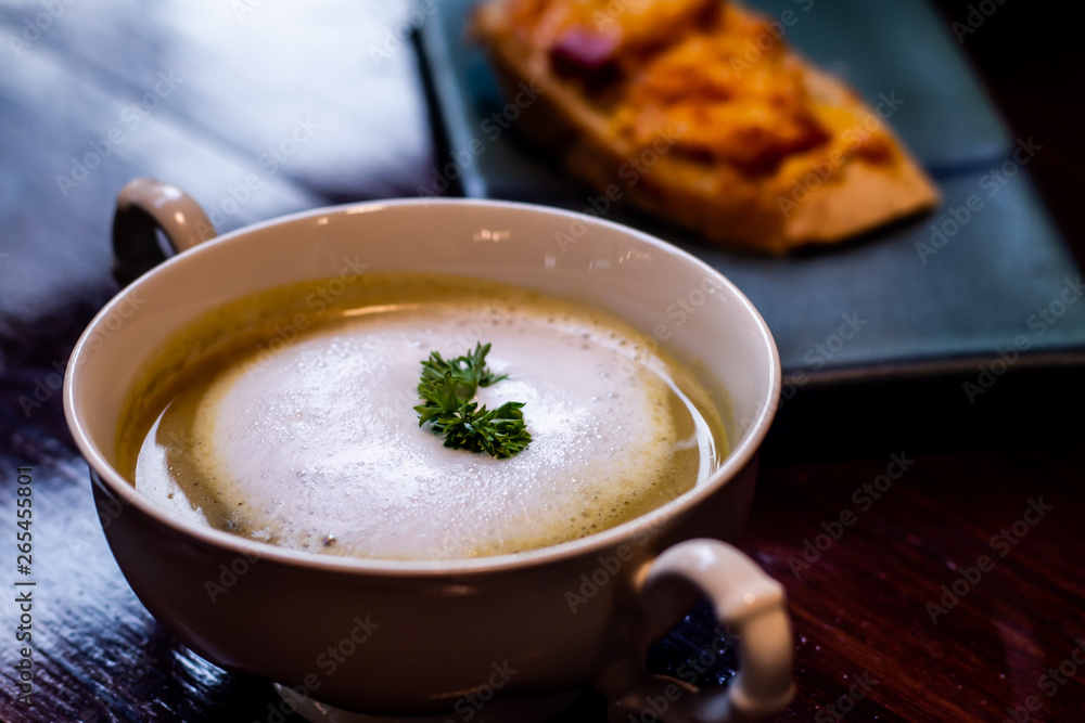 close up of mushroom soup in white ceramic cup on table close up of mushroom soup in white ceramic cup on table