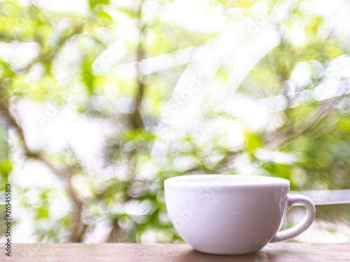 cup of coffee on table in cafe, Morning light blur bokeh nature background