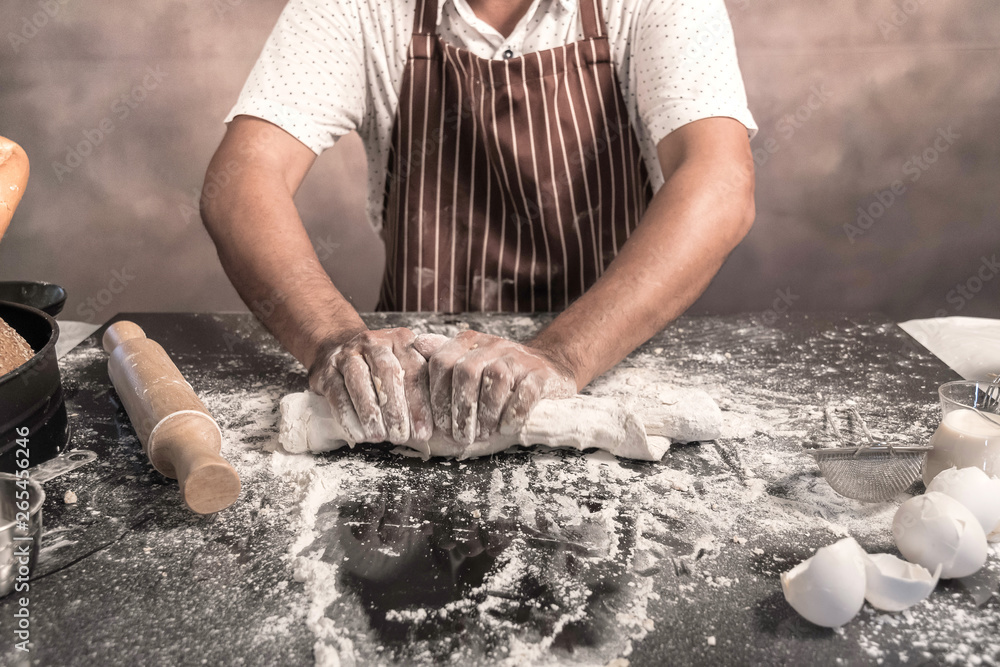 Man preparing buns at table in bakery Man preparing buns at table in bakery