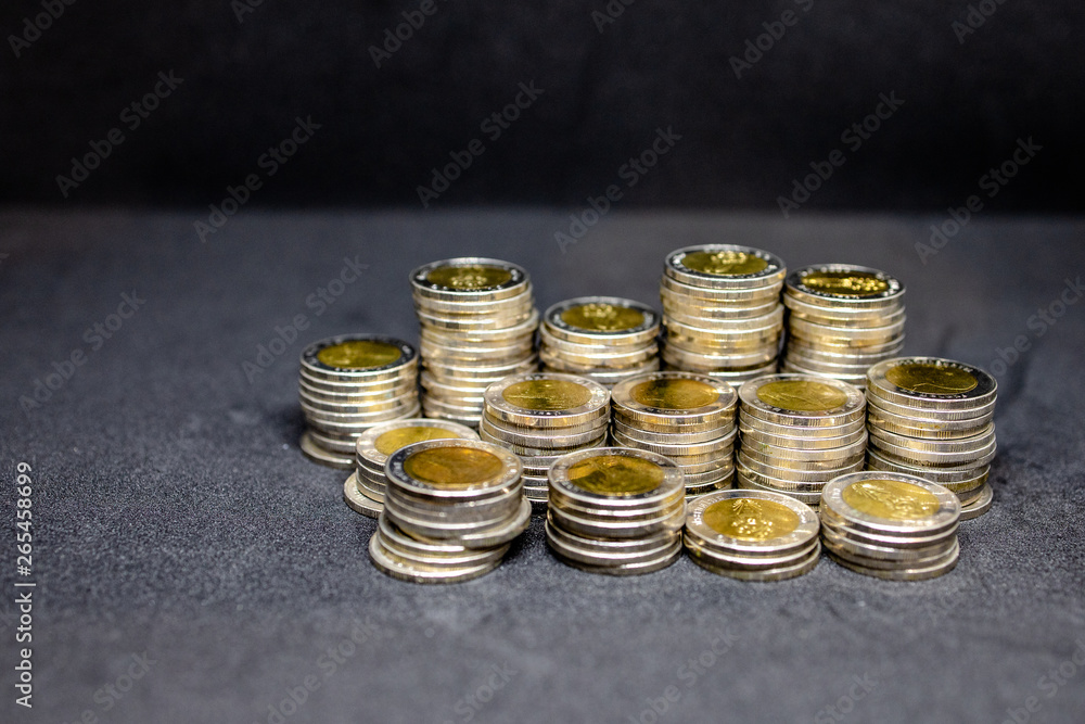 Currency in Thai baht Coin with golden and silver color on black background. Abstract of saving money Currency in Thai baht Coin with golden and silver color on black background. Abstract of saving money