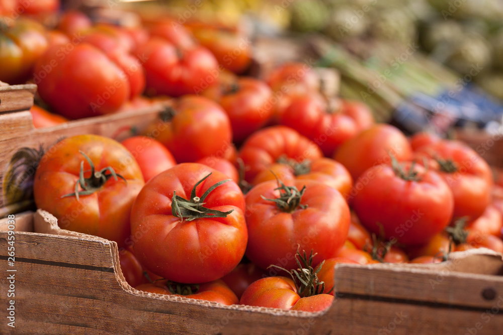 fresh tomatoes on branch in wicker baskets on counter fresh tomatoes on branch in wicker baskets on counter