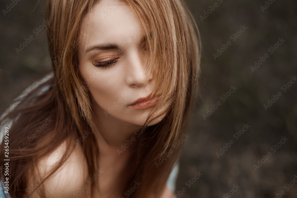Portrait of a thoughtful girl with long hair. Copy space