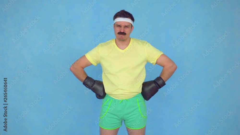 Serious man with a mustache from 80 x in Boxing gloves Serious man with a mustache from 80 x in Boxing gloves